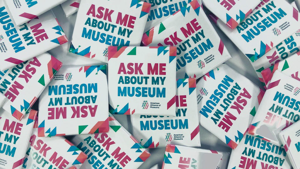 Image of several buttons that state: Ask me about my museum, with the AAM logo on them.