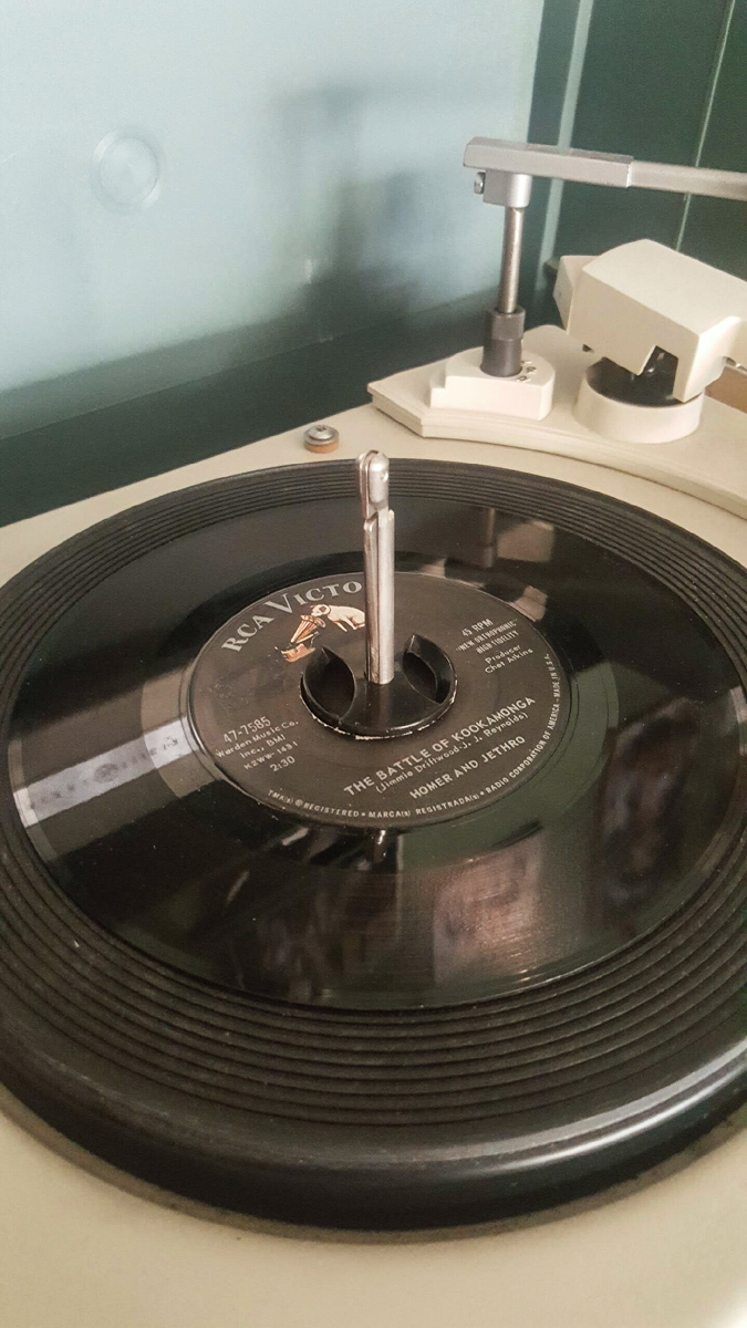 Record with label reading "The Battle of Kookamonga" on a turntable.