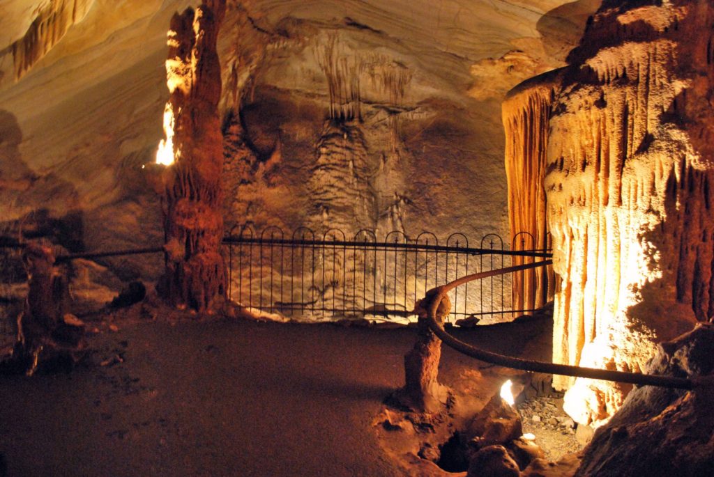 A lit and gated pathway inside Bristol Caverns.