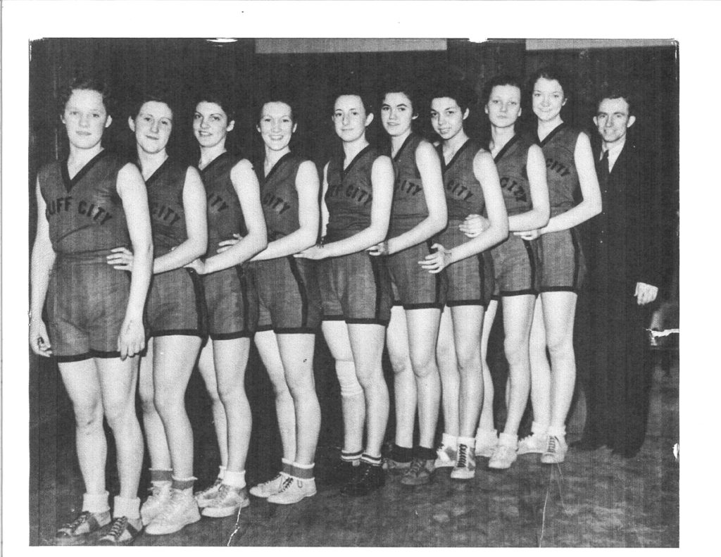 Black and white photo of girls' basketball team -- 9 players and 1 coach
