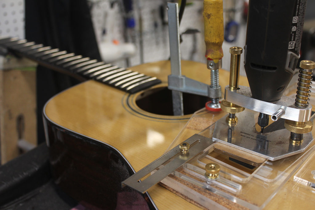 Close up of a Jimmy Edmonds guitar in its framing, reading to be worked on.