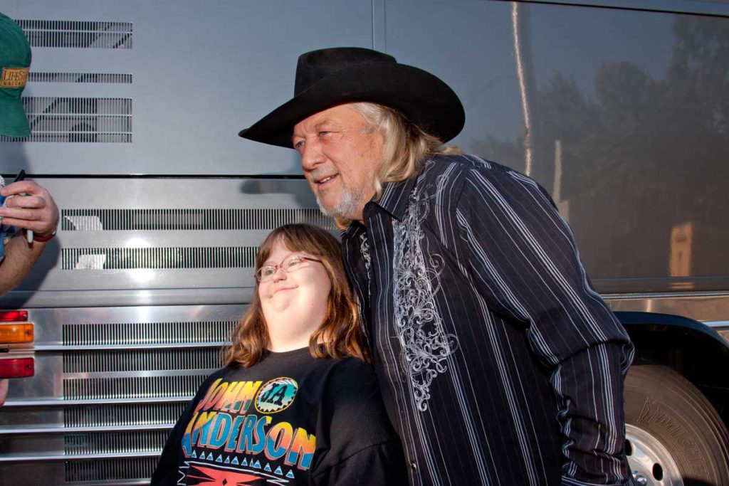 Country music star John Anderson posing with a young fan wearing his t-shirt during Bristol Rhythm 2010.
