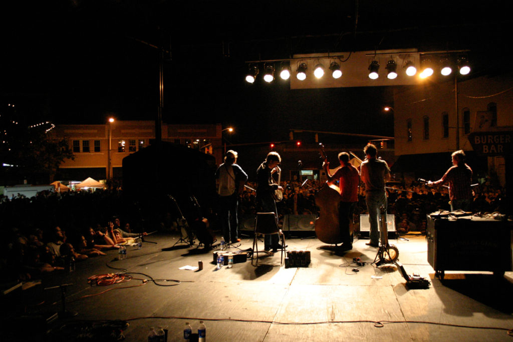 Old Crow Medicine Show on stage at Bristol Rhythm 2005, seen from behind looking out at audience