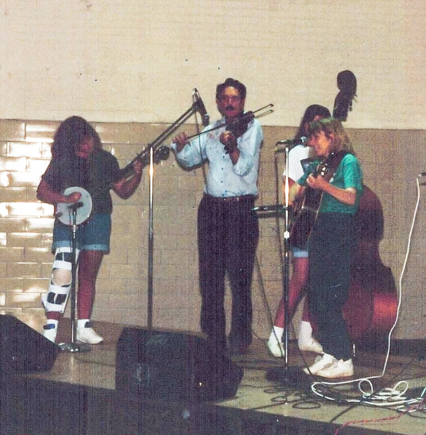 A teenage Trish Fore playing banjo onstage with Thornton Spencer and Emily Spencer.