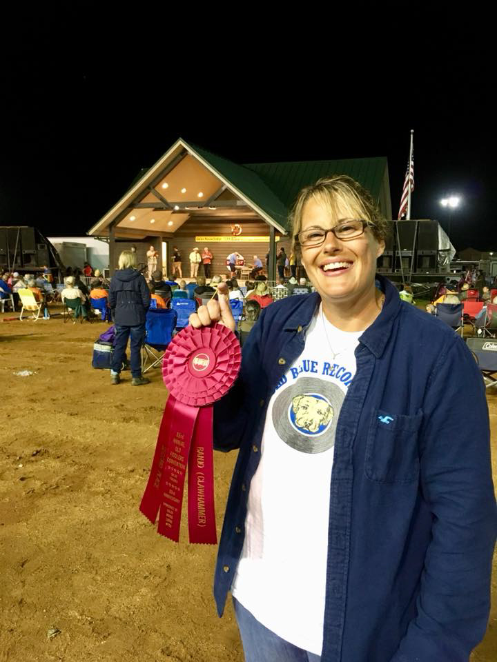 Trish Kilby Fore standing near the performance stage with her second place ribbon.