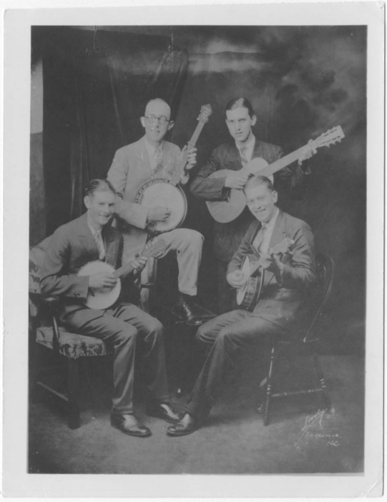 Portrait of Tenneva Ramblers with Jimmie Rodgers -- two seated musicians and two standing.