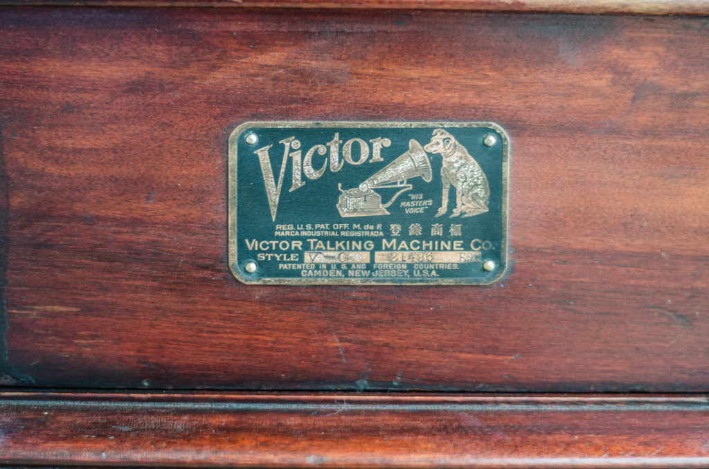 Close up of small metal plaque bearing the Victor logo.