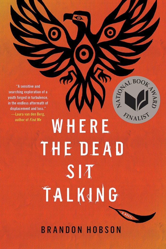 The book cover is red with a black graphic of an eagle in the Native art style at the top of the cover and the title in white beneath it. It has a sticker on it saying "National Book Award Finalist."