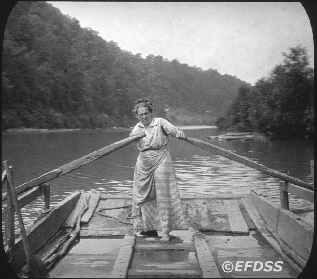 Black-and-white image of a woman pulling the oars on a barge in Appalachia.