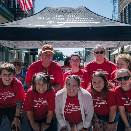 Bristol Rhythm & Roots Reunion volunteers posing in front of a festival tent.