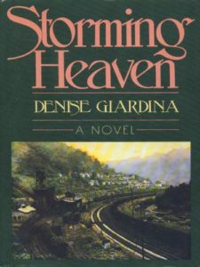 The cover of the book is dark green with the title in a pink or peach color. Below the title and author, an image of a coal town in the mountains is seen with a railroad track leading into it from the right side of the picture.