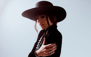 A photo of Nicki Bluhm wearing a wide-brimmed hat.
