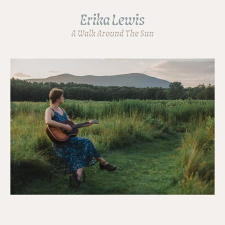 The album cover has the artist's name and album title at the top. The image underneath shows a young white woman in a blue-patterned dress sitting in a field and playing a guitar. She has curly-ish brown hair, pulled back at the nape of her neck, and she is looking into the distance towards the mountains.