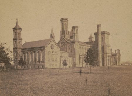 A sepia print image of the original Smithsonian building -- a turretted, castle-like brick building.