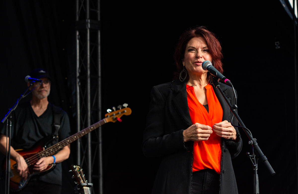 Rosanne Cash speaking into a microphone.