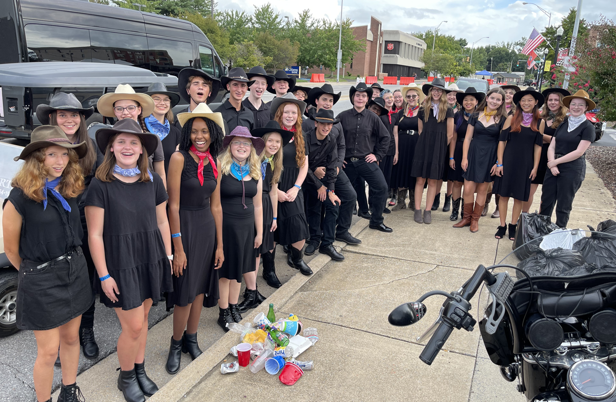 Photo of the Mountain Empire Children's Choral Academy's Highlands Youth Ensemble, boys and girls, dressed in black and wearing cowboy hats.