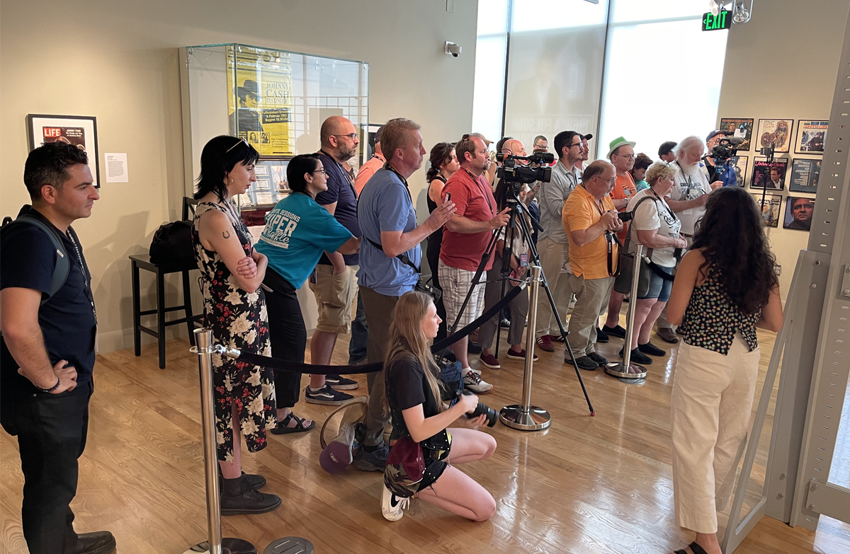 More than a dozen journalists line up in the special exhibit 