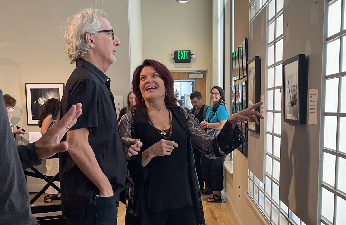 Rosanne Cash pointing out a photo to her husband, John Levanthal