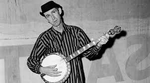 Photo of David "Stringbean" Akeman holding a banjo.