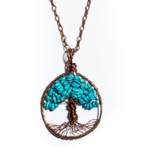 A pendant dangling from a bronze chain. The pendant is made from twisted bronze wire, and shaped into a tree in the center. The "leaves" of the tree are made of tiny stones.