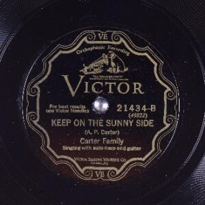 An old record with a weathered label depicting a dog listening to a phonograph over the word "Victor." Underneath, it reads "Keep on the Sunny Side" (A.P. Carter), Carter Family singing with auto-harp and guitar.