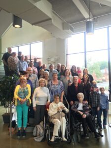 A picture of a large group of people standing on the staircase at the Birthplace of Country Music Museum. It is the reunion of the descendants of Sessions musician Alfred Karnes.