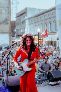 A photo of Hannah Dasher performing before a large crowd on the 6th Street Stage during the 2024 Bristol Rhythm & Roots Reunion music festival.