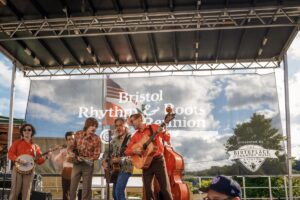 A photo of Jim Lauderdale performing with Wyatt Ellis and his band on the Country Music Mural Stage at Bristol Rhythm & Roots Reunion.