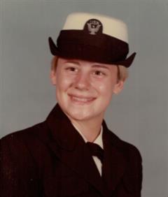 Young woman with short blonde hair in Navy uniform.