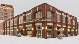 An image of the exterior of the Birthplace of Country Music Museum with snow on the ground.